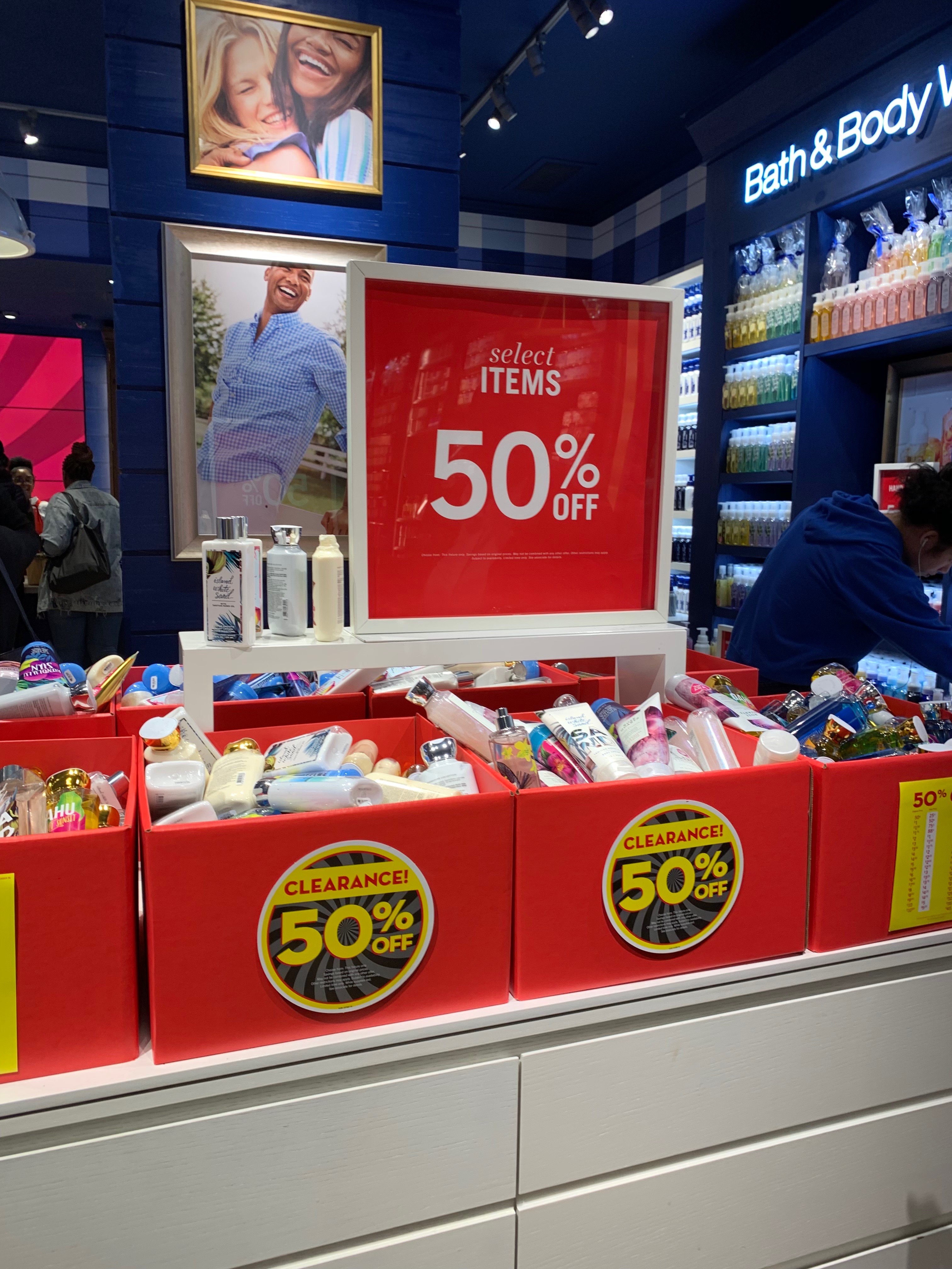 Red clearance bins marked 50% off at Bath and Body Works.